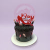 One-tier fashion-themed birthday cake with dark gradient frosting, lipstick decorations, and a red 'Stay Fabulous' topper.