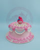 One-tier My Melody birthday cake with pink buttercream, white daisies, blue/white ruffles, and 'Happy Birthday Aliha' lettering.