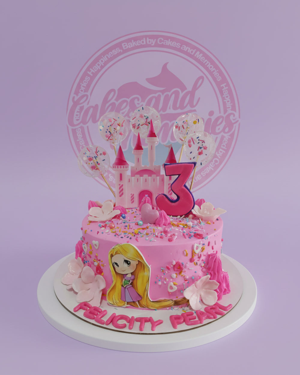 One-tier Rapunzel princess birthday cake with castle topper, '3', edible print, sprinkles, and 'Felicity Pearl' in pink.