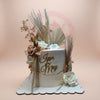 Custom wedding cake with boho dried florals, sugar roses, and 