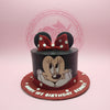 1-tier Minnie Mouse birthday cake with black buttercream, red polka dots, fondant ears and bow, and 'Happy 1st Birthday Bennett' text.