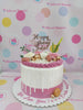One-tier rose gold drip birthday cake for Julie with white and pink roses, macarons, and golden spheres.