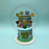 Geometry Dash 10th birthday cake with geometric character toppers, 'CZARCHIS10' and a large '10' cutout, in blue and green.