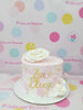 One-tier custom birthday cake with elegant pink buttercream, gold flakes, white sugar flowers, and a 'Zia Eleese' gold topper.