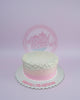 One-tier round buttercream cake with white to pink ombre icing, adorned with edible pearls and 'LOVE: JOAQUIN' text.