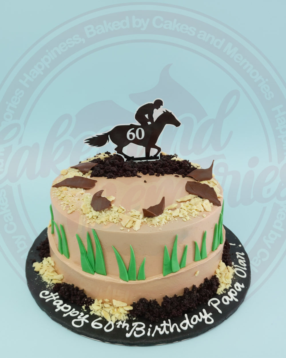 Custom 60th birthday cake with horse racing theme, jockey and horse topper, brown icing, green grass, and 'Happy 60th Birthday Papa Olan!' text.