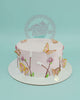 One-tier round pink buttercream cake with hand-piped botanical designs, white sprinkles, and gold-edged butterfly toppers.