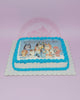 One-tier rectangle birthday cake with Bluey edible photo print for Evia's 7th birthday, blue piping, and white icing.