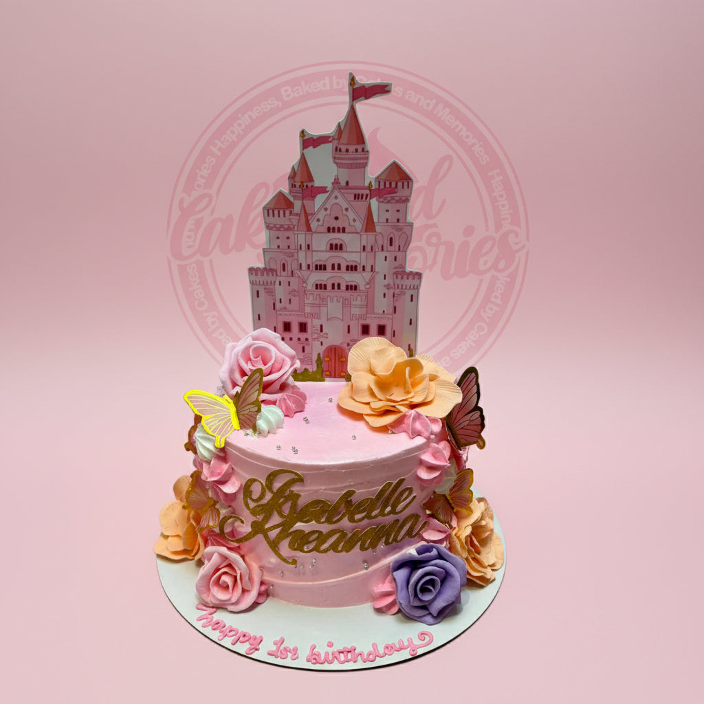 One-tier round pink buttercream 1st birthday cake with a princess castle topper, floral decorations, butterflies, and "Isabelle Raeanna" text.