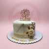 White fondant wedding cake with elegant lace details, cream roses, and a golden 'Mr & Mrs' tree topper. Personalized with names and date.