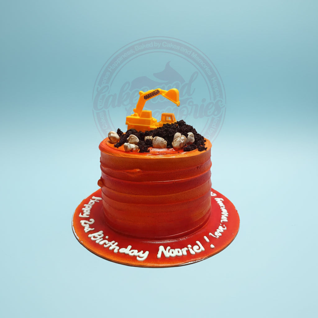 One-tier construction birthday cake with orange ombre buttercream, edible dirt and rocks, and a yellow toy excavator. Happy 2nd Birthday Nooriel.