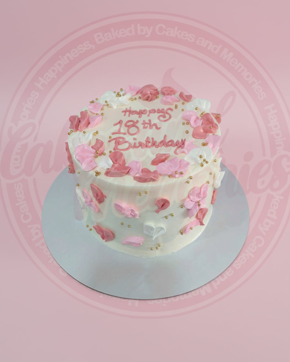 1-tier 18th birthday cake with pink and white buttercream flowers, gold pearls, and 'Happy 18th Birthday' text