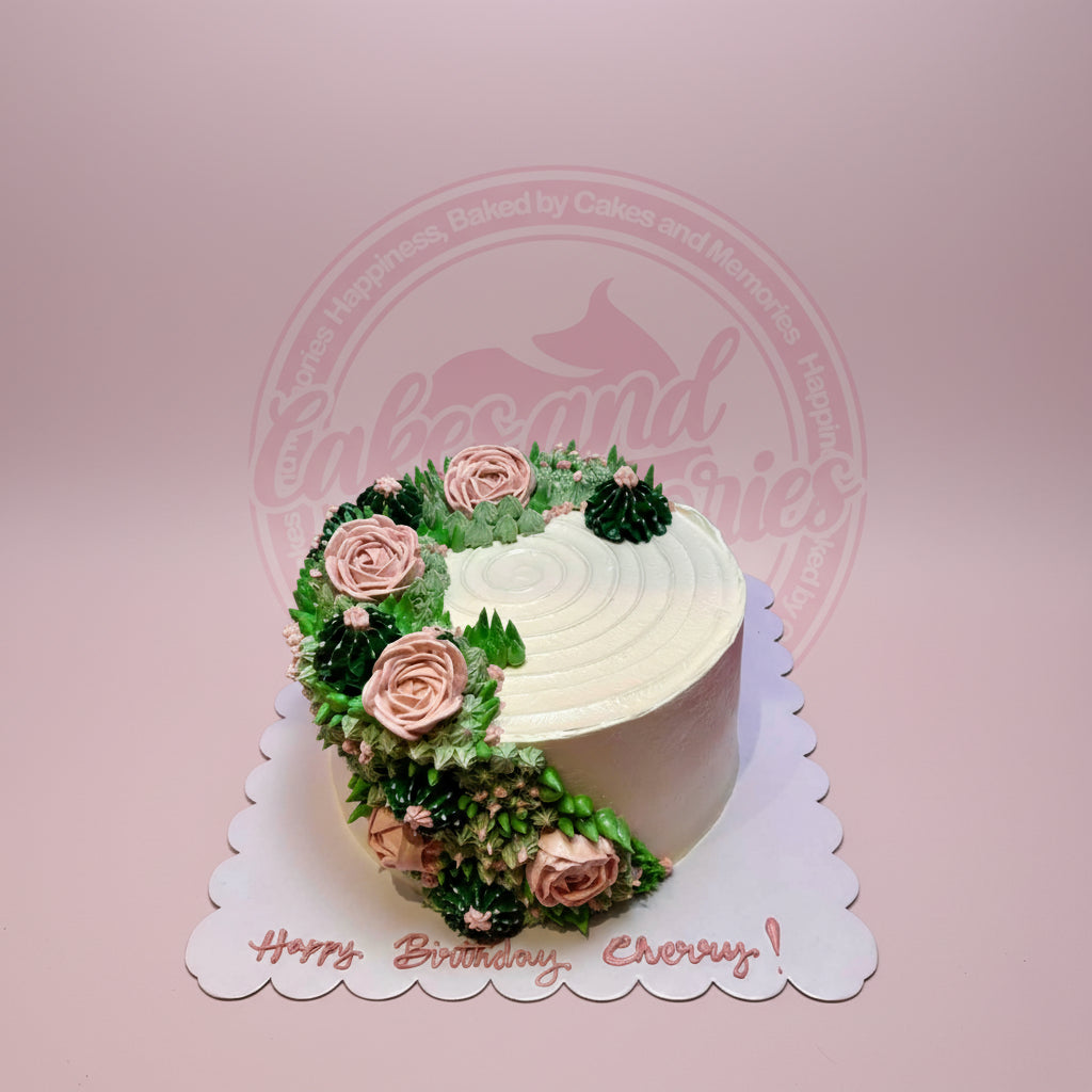 One-tier round buttercream birthday cake with pink roses and green succulents, 'Happy Birthday Cherry!' on board.