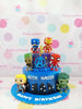Two-tier Avengers birthday cake with Funko Pop superhero figures, cityscape, and 'KEITH KAIZER 10' text in blue and purple.