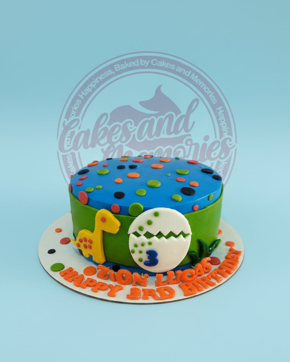 One-tier Dinosaurs Cake for Zion Lucas's 3rd birthday, with yellow baby dino, cracked egg with '3', and colorful spots on blue and green icing.