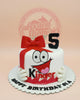 One-tier fondant birthday cake with Kinder Surprise character design, red bow, black 5, and 'Happy Birthday Sia' text. White, red, black.
