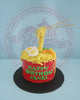 One-tier ramen birthday cake for Janel, featuring a red bowl, yellow noodles, fondant eggs, shrimp, veggies, and chopsticks.