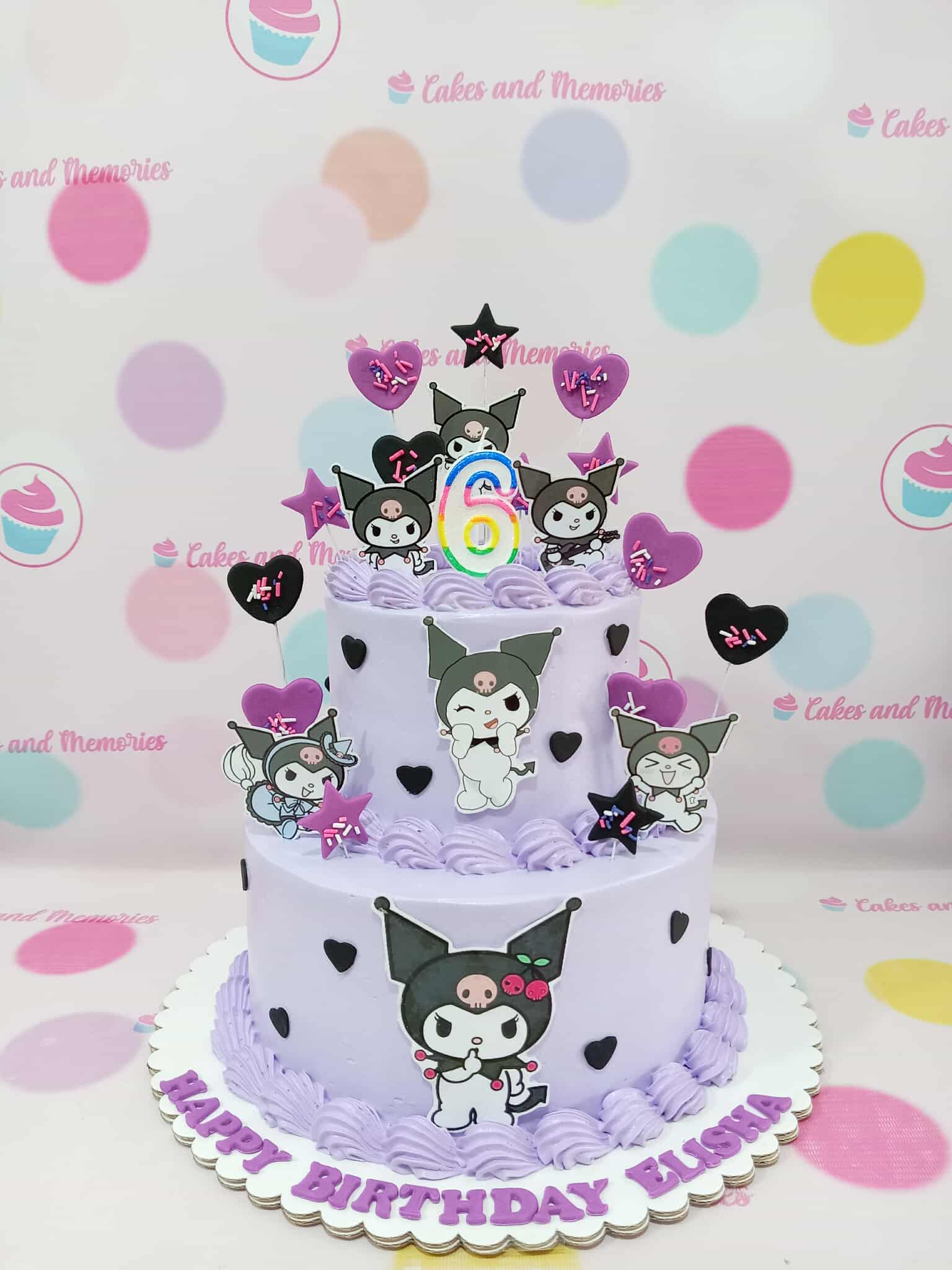 Two-tier Kuromi buttercream cake in lavender with printout toppers, heart sprinkles, and "Happy Birthday Elisha 6" text.