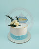 Christening cake with pale pink and light blue buttercream, white roses, pearl accents, and 'Eli Christening' topper.