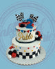 Two-tier racing birthday cake for Pablo with red race car, blue '2' topper, checkered flags, and colorful accents.
