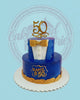 Two-tier 50th birthday cake designed as an elegant blue suit with gold bow tie, 'RAMIL @50' plaque, and gold '50' topper.