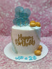 One-tier birthday cake with white & blue buttercream, gold 