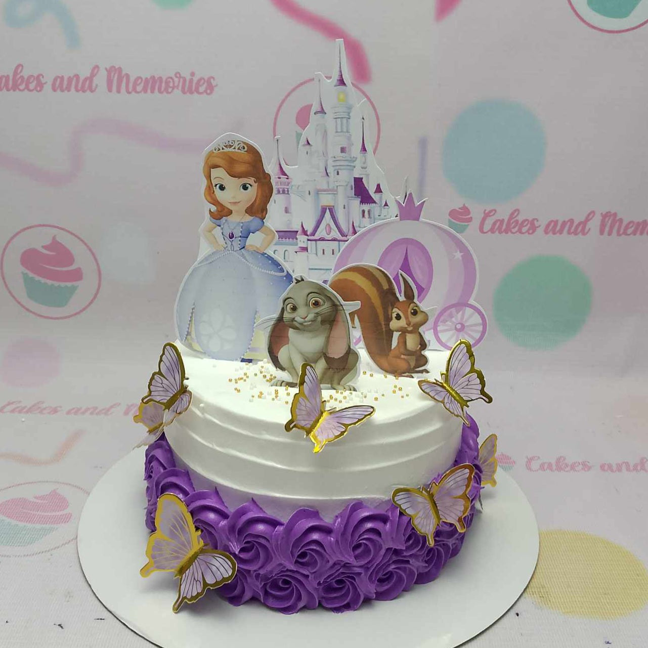 Introducing the enchanting Sofia Cake, a stunning one-tier creation adorned with delicate white and purple rosettes, whimsical butterflies, and a charming castle fit for a princess. Perfect for kids' birthday celebrations, this customized cake is complemented by delightful printout toppers to make the day truly special.