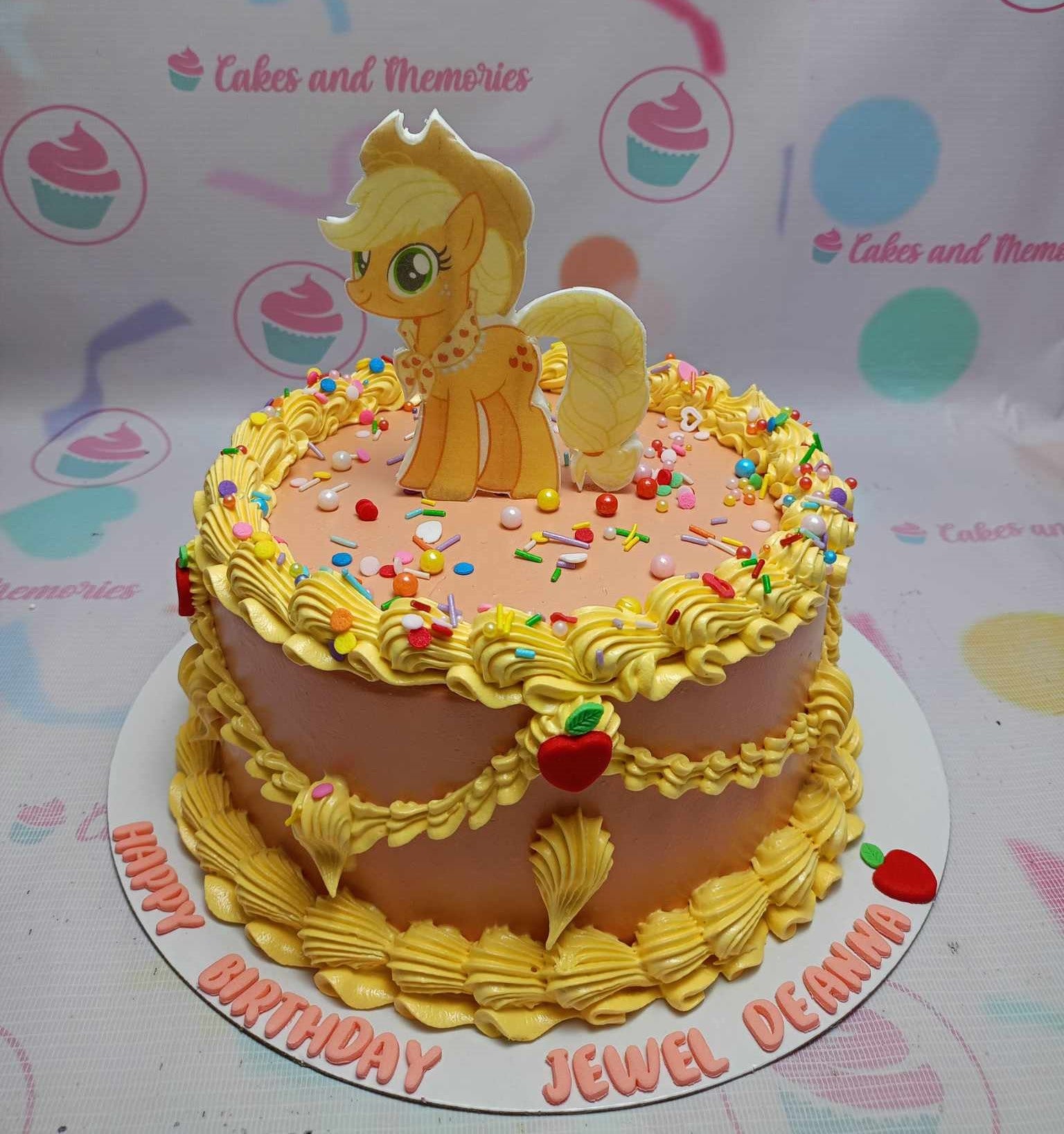 Celebrate your child's special day with our vibrant My Little Pony Cake, featuring a charming vintage look in orange, peach, and brown hues. Adorned with colorful sprinkles and a delightful printout topper of Applejack, this customized one-tier birthday cake is perfect for little pony fans!