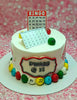 A charming Bingo Cake featuring a white, one-tier design adorned with bingo cards, bingo balls, and a festive calendar. Perfectly designed for a 32nd birthday celebration, it showcases printout toppers that enhance its bingo-themed appeal.