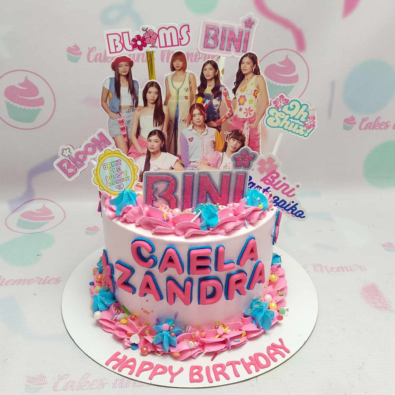 Introducing our stunning Bini Cake featuring a vibrant mix of pink and purple hues. Adorned with beautiful blooms, this one-tier cake is a colorful tribute to Pinoy pop and Kpop culture, perfect for any celebration!