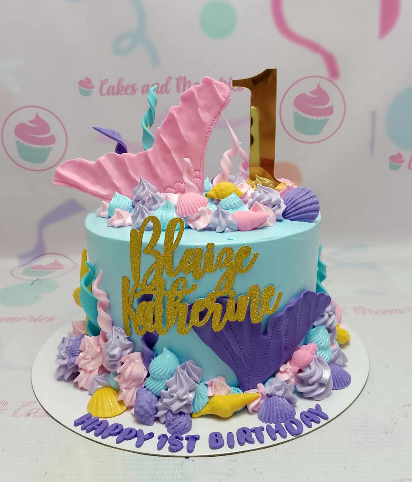 Dive into a magical underwater adventure with our stunning Mermaid Cake, featuring a vibrant teal and blue design adorned with pink and purple mermaid tails, gold glitter toppers, and charming shells. Perfect for birthday celebrations, this one-tier creation captures the essence of the little mermaid and is sure to delight children and girls alike!