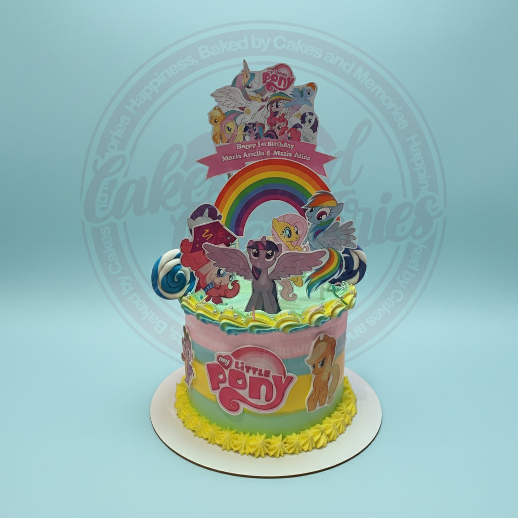 One-tier My Little Pony 1st birthday cake with rainbow, character toppers, and 'Maria Ariella & Maria Aliza' banner in pastel colors.