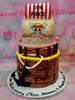 This vibrant One Piece Cake features a whimsical design with fondant details, showcasing a pirate ship inspired by the Strawhat Pirates. Adorned with printout toppers of Monkey D. Luffy, a black anchor, and the Going Merry, it's the perfect centerpiece for any child's birthday celebration.