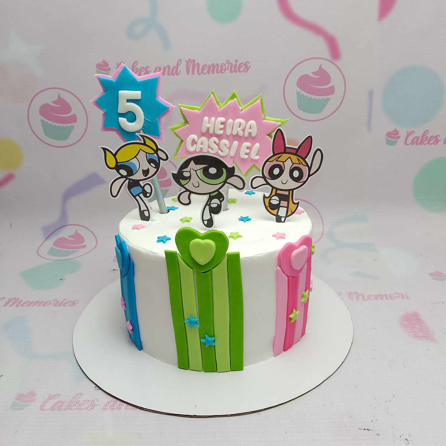 Celebrate your special day with this vibrant 1-tier Power Puff Girls cake, featuring Blossom, Bubbles, and Buttercup in a delightful white, blue, green, and red design. Perfect for fans of Cartoon Network, this customized cake showcases printed toppers of Mojo Jojo and the beloved trio, making it an ideal choice for any birthday celebration.