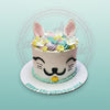 Custom birthday cake with a cute white cat face, pastel buttercream swirls, pink ears, and 