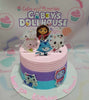 A vibrant, one-tier cake decorated in shades of pink, purple, blue, and teal, featuring playful printout toppers inspired by DreamWorks' Gabby's Dollhouse. Perfectly designed for a birthday celebration with a whimsical animated theme.