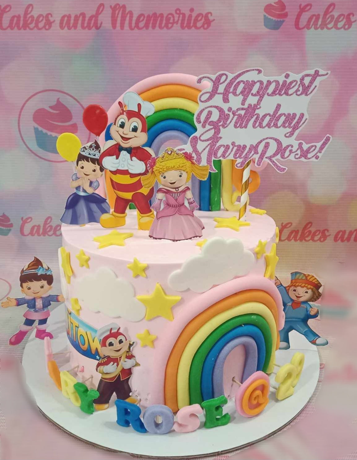 A delightful Jolibee Cake adorned with a colorful rainbow edible topper featuring Jolibee, Hetty Spaghetti, Twirlie Sundae, Champ, Popo French Fries, and Yum Burger. This one-tier, single-layer cake is perfect for a Pinoy birthday celebration.