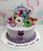 The Smiling Critters Cake features a playful purple design adorned with cheerful characters perfect for a boy's 9th birthday celebration. This delightful one-tier cake showcases colorful printouts and fun Poppy Playtime toppers, making it a festive centerpiece for a happy birthday.