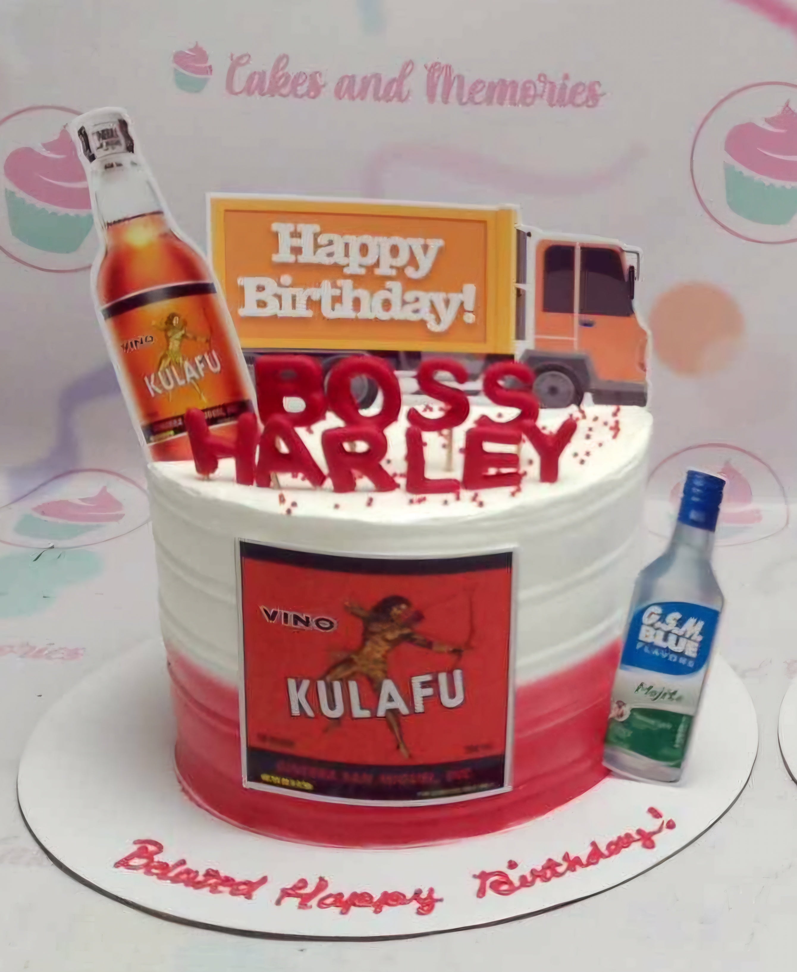 A stunning custom Drinks Cake featuring a one-tier design in white, red, and orange, adorned with printout toppers including a delivery truck and a vino kulafu bottle. Perfect for a celebration, this cake wishes "Happy Birthday Sir" while showcasing a G.S.M Blue mojito theme, all priced at P250 for delivery.