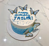 This Butterflies Cake features a stunning blue ombre design with delicate white butterflies and colorful sprinkles. The minimalist design is complemented by unique printout toppers, showcasing an elegant single layer and tier.