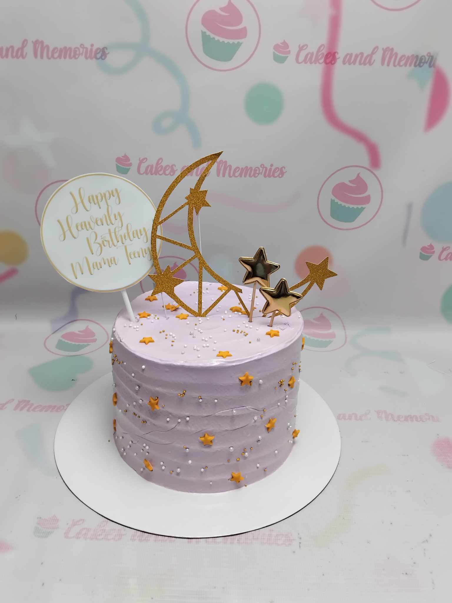 Introducing our stunning Stars Cake, featuring a harmonious blend of pink and purple hues adorned with delicate lavender accents. This one-tier masterpiece showcases dazzling golden stars and a shimmering gold moon crescent, perfect for any birthday celebration or galaxy-themed event.