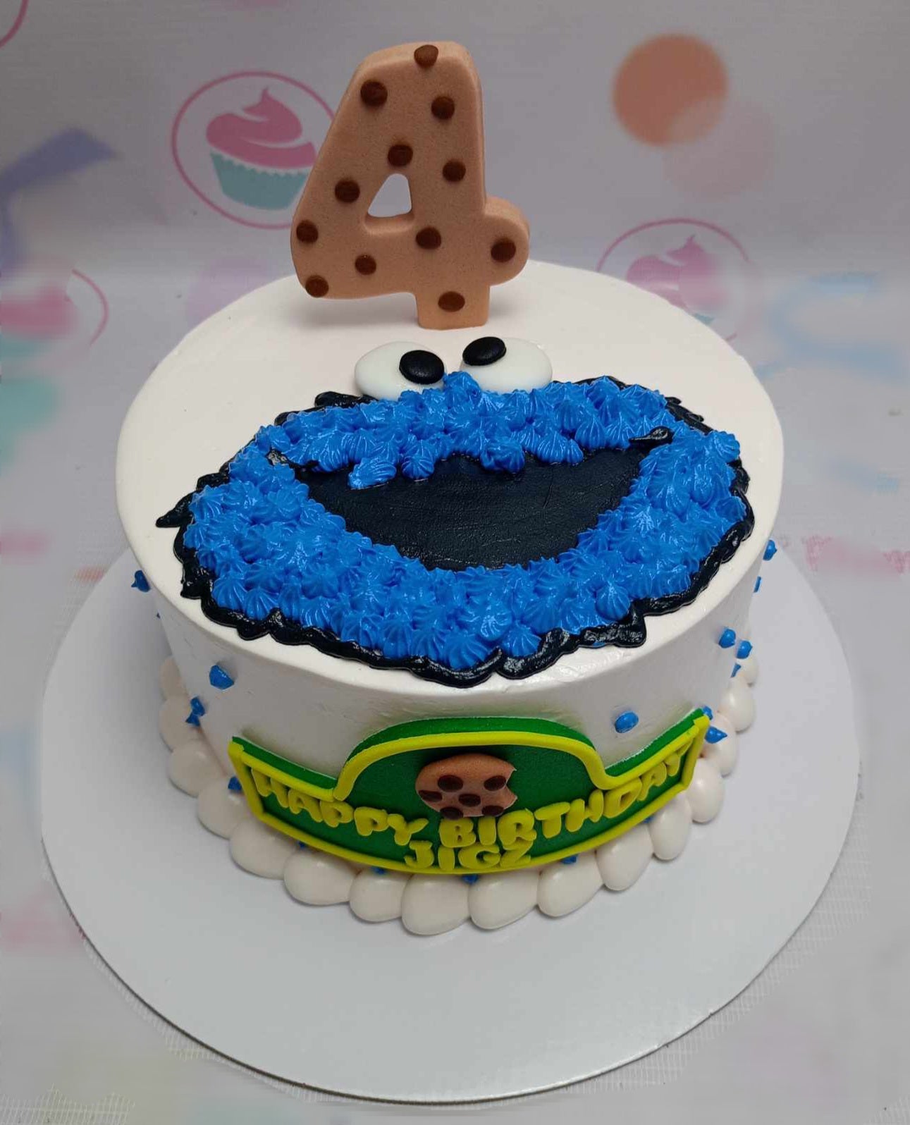 This custom Sesame St Cake features a delightfully crafted Cookie Monster in blue, perfect for a 4th birthday celebration. The single-tier design showcases a crisp white finish, making it a charming centerpiece for the occasion.