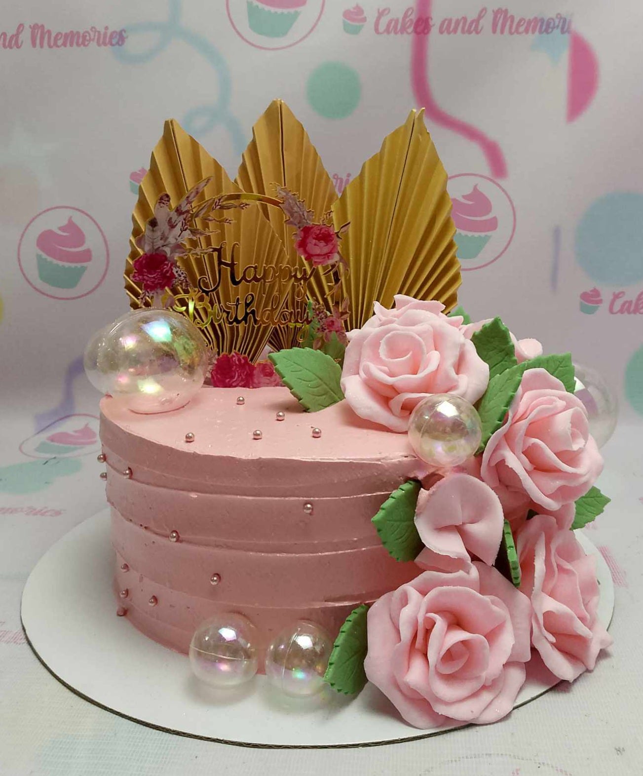 This stunning floral cake features pink roses and delicate leaves, elegantly adorned with gold fan accents, bubbles, and gold sprinkles. Perfect for celebrating milestone birthdays, from 50th to 80th, it's a memorable centerpiece for Lola, Tita, Mama, or Mommy.