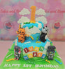 This custom Listener Kids Cake features a two-tier design in blue, white, orange, green, and yellow, adorned with delightful edible toppers of a tiger, panda, and robot against a backdrop of fluffy clouds. Perfectly personalized with the names Juan and Marco, this cake celebrates a 1st birthday with an educational theme related to Christian videos for kids and Sunday school.