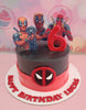 Celebrate a 6th birthday with this vibrant Deadpool-themed cake, featuring a whimsical design in red and black. The cake showcases Marvel character printout toppers, including Dogpool, making it perfect for any superhero fan.