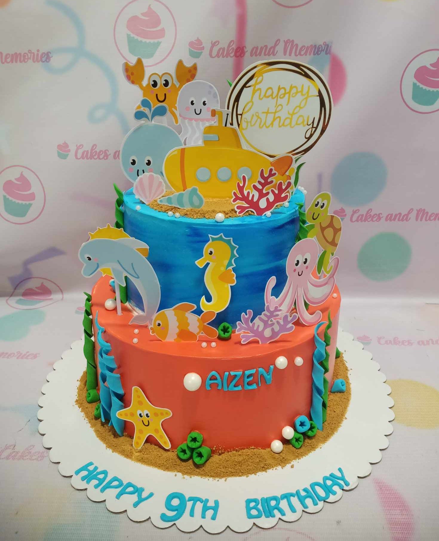 This enchanting Under the Sea Cake features vibrant blue and orange hues, adorned with playful under the sea creatures and a charming yellow submarine. With two tiers of delightful design, it's the perfect customized birthday cake for kids, especially fans of mermaids and the little mermaid theme.