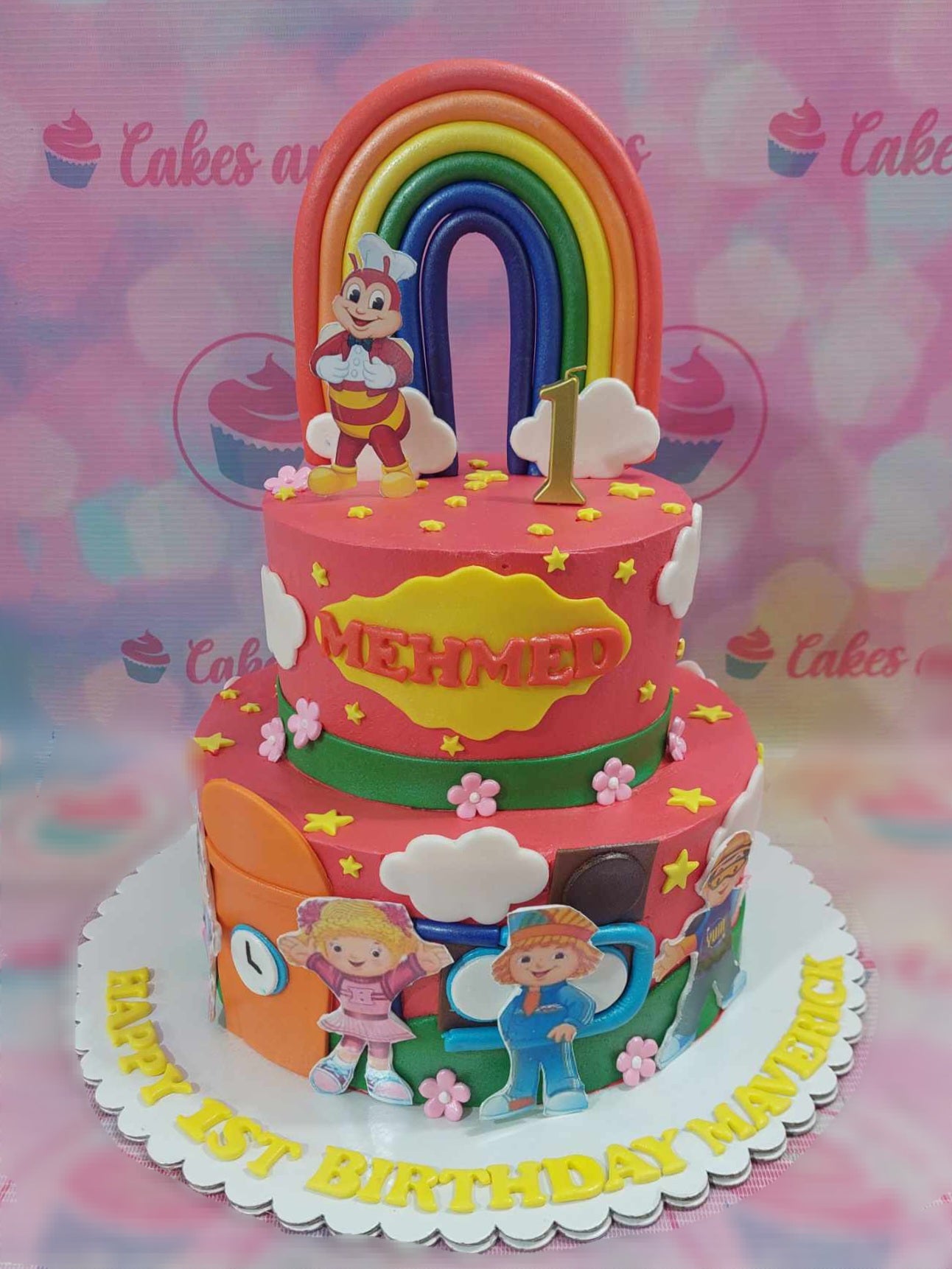 This delightful Jolibee Cake features a cheerful red and yellow design, perfect for a toddler's 1st birthday party. Adorned with rainbow edible toppers of Jolibee, Hetty Spaghetti and Popo, this two-tier cake will be a standout centerpiece for any celebration.