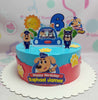 This 1-tier Cartoon Cake features a playful design with blue and red colors, showcasing police dog characters, paw prints, and a police car. Perfect for Raphael James' 6th birthday, it highlights a number six and includes fun printout toppers, all surrounded by a sunny theme.