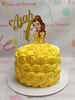 The Belle Cake features a stunning yellow design adorned with elegant rosettes and charming swirl details, perfect for a 7th birthday celebration. Disney princess printout toppers of Belle enhance the cake’s beauty, making it a delightful centerpiece for any party.