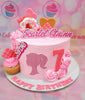 Celebrate a 7th birthday with this custom Barbie cake featuring a pink color scheme adorned with sprinkles, rosettes, and playful toppers including a girl head silhouette and floral accents. Perfect for a girly celebration, this single-tier cake captures the essence of fun with hearts, cupcakes, and donuts.